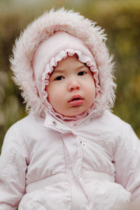 Portrait of cute baby girl in snow
