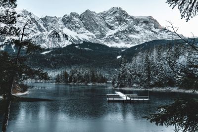 Scenic view of snowcapped mountains and lake during winter