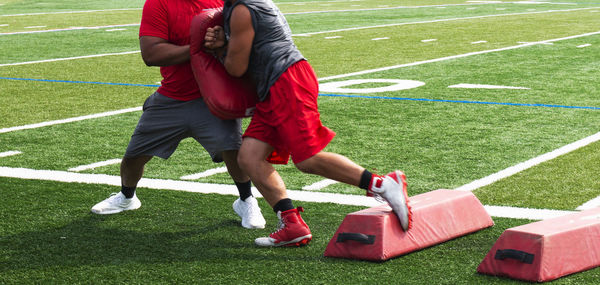 Low section of man playing on grassland