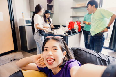 Happy siblings and woman in corridor