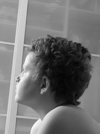Close-up side view of thoughtful boy looking away at home
