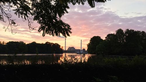 Silhouette of trees against cloudy sky
