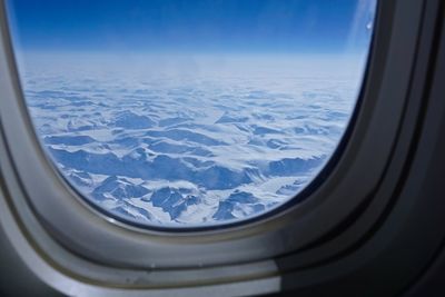 Aerial view of landscape seen through airplane window