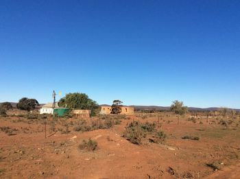 Scenic view of land against clear blue sky