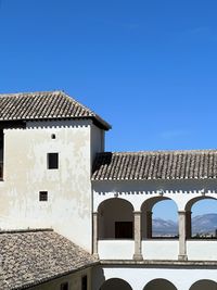 Low angle view of building against clear blue sky