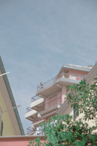 Low angle view of buildings in town against sky