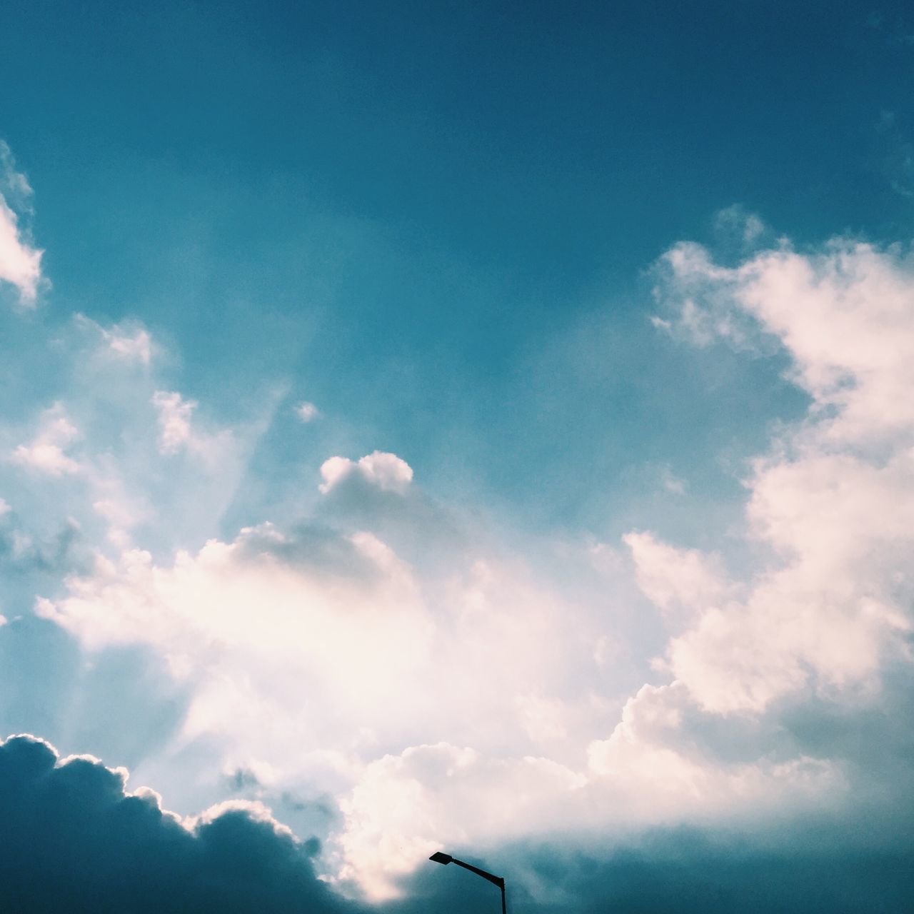 low angle view, sky, blue, cloud - sky, transportation, airplane, cloud, flying, nature, mode of transport, air vehicle, beauty in nature, scenics, part of, cloudy, mid-air, cloudscape, outdoors, tranquility, no people