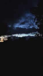 Scenic view of silhouette landscape against sky at night