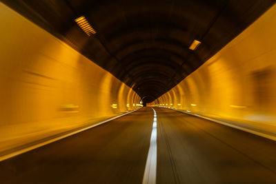 Blurred motion of train at illuminated tunnel