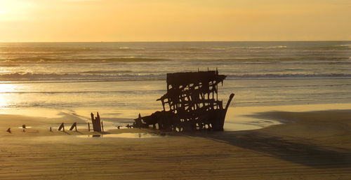 Scenic view of beach against sky during sunset