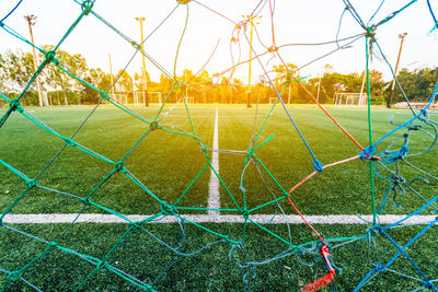 View of soccer goal against sky during sunset