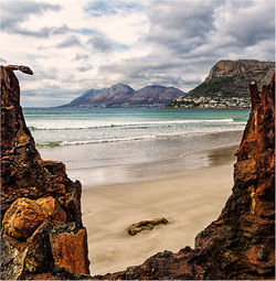 View of beach against cloudy sky