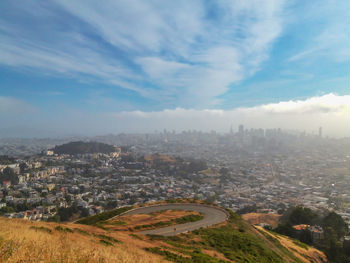 High angle view of city against cloudy sky