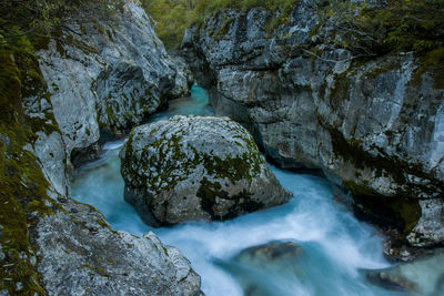 High angle view of stream amidst rocks