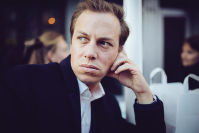 Close-up of thoughtful businessman looking away in city