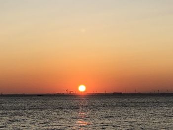 Scenic view of sea against romantic sky at sunset