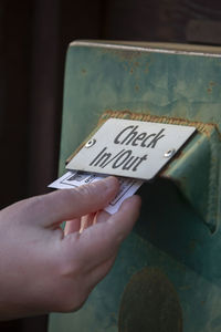 Cropped hand of man holding text