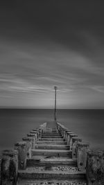 Pier over sea against sky