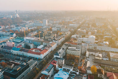 Aerial view of buildings in city during sunrise