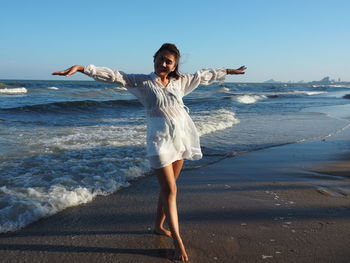 Full length of woman standing on beach