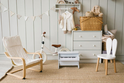 Scandinavian interior design of a playroom with modern designer furniture, a toy piano, soft toys