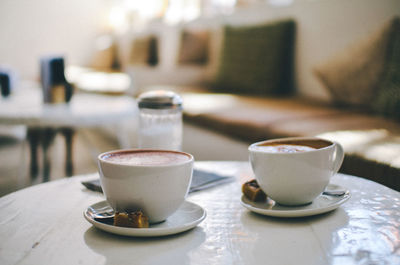 Close-up of coffees served on table