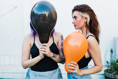 Young woman holding balloons