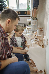 Boy sitting in kitchen