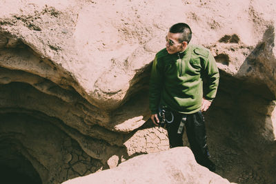 Portrait of young man standing on rock