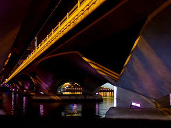 Low angle view of bridge over river at night