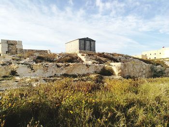 View of old ruin building against cloudy sky