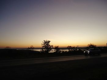 Cars on road at sunset