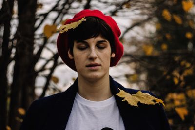 Portrait of young man looking away outdoors