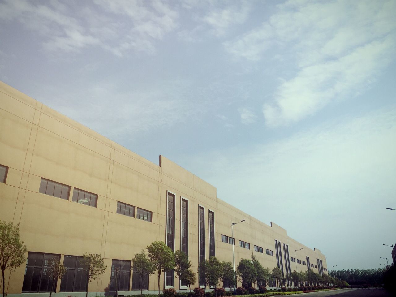 architecture, built structure, building exterior, sky, low angle view, building, city, cloud - sky, residential building, tree, day, outdoors, residential structure, cloud, window, no people, cloudy, city life, bridge - man made structure, connection