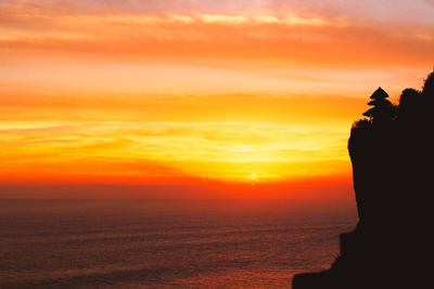 Scenic view of sea against orange sky