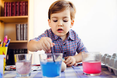 Boy painting egg