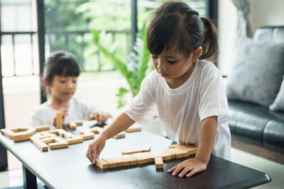 Boy and girl sitting on table