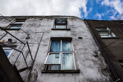 Low angle view of abandoned building against sky