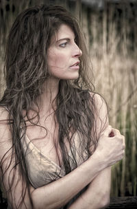 Portrait of young woman looking away outdoors