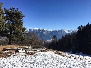 Scenic view of snowcapped mountains against clear blue sky