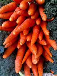 High angle view of carrots by broccoli for sale at market stall
