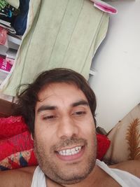 Portrait of smiling young man at home