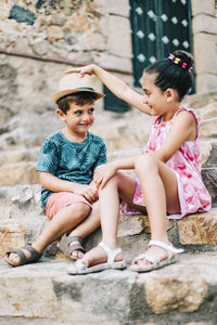 Cute sibling sitting on staircase