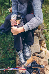 Low section of man holding ice cream cone on land