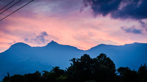 Scenic view of silhouette mountains against sky at sunset