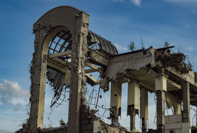 Low angle view of abandoned building against sky