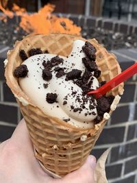 Close-up of hand holding ice cream cone