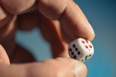 Close-up of person holding a dice at night