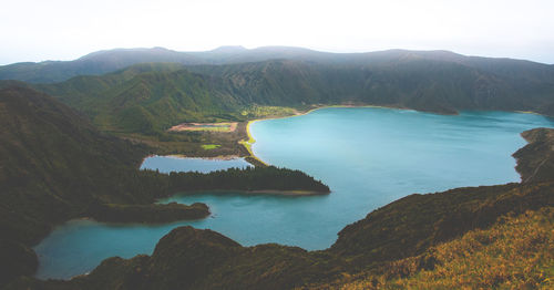 Scenic view of lake and mountains against clear sky