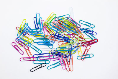 Close-up of colored pencils over white background